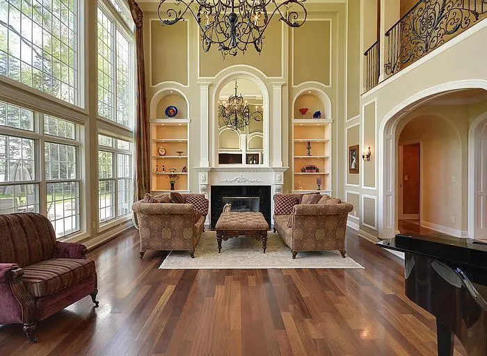 A living room with two chairs and a fireplace.