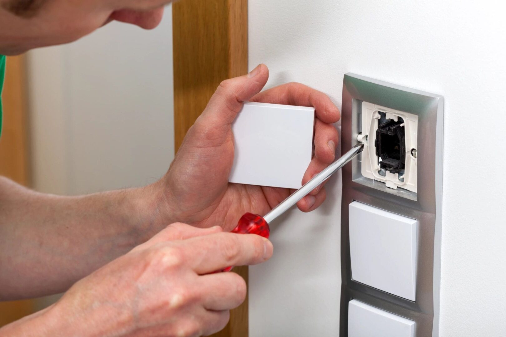 A Person Fixing A Socket With Tools